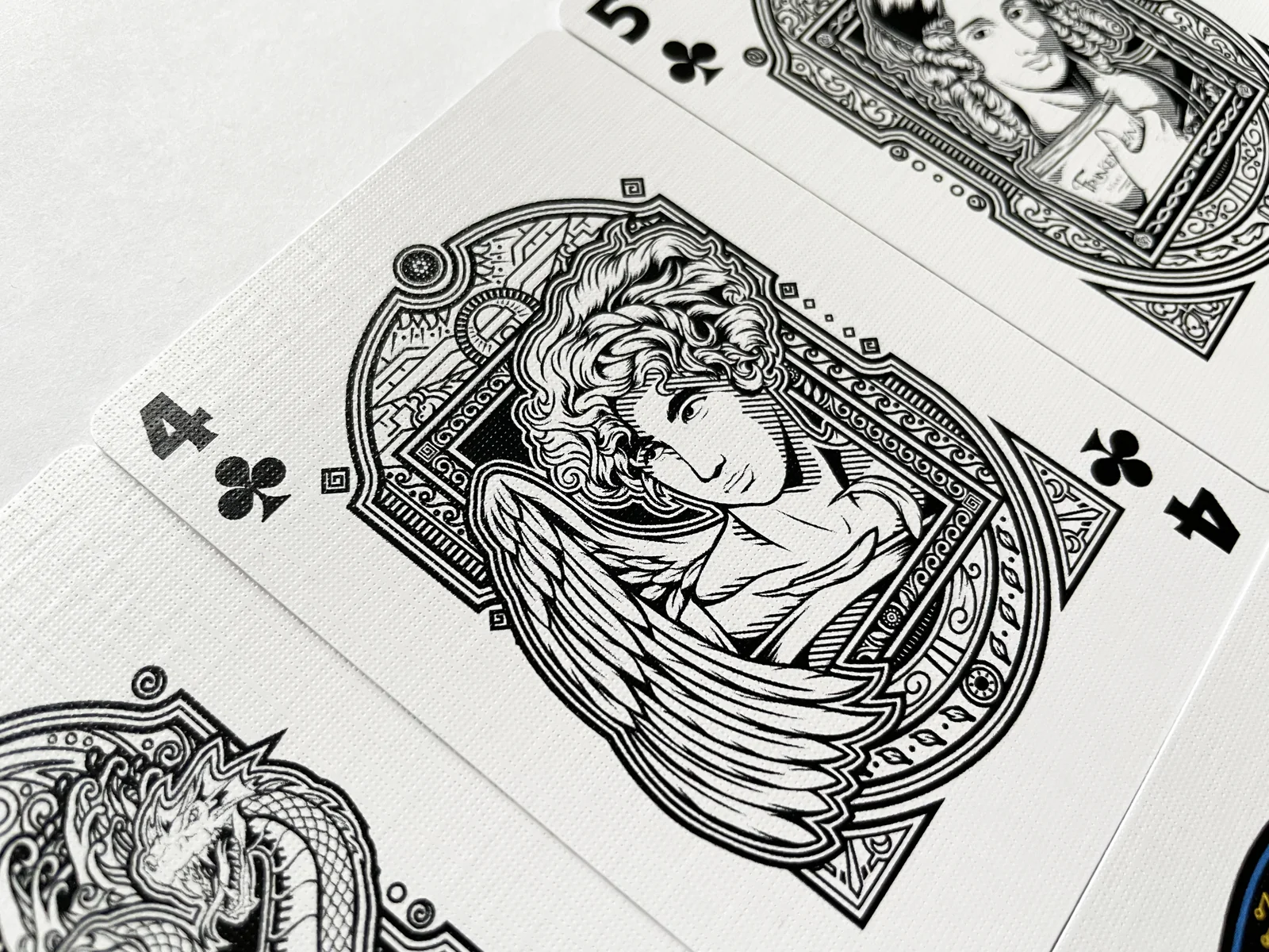 Close view of the illustrated Four of Clubs card.