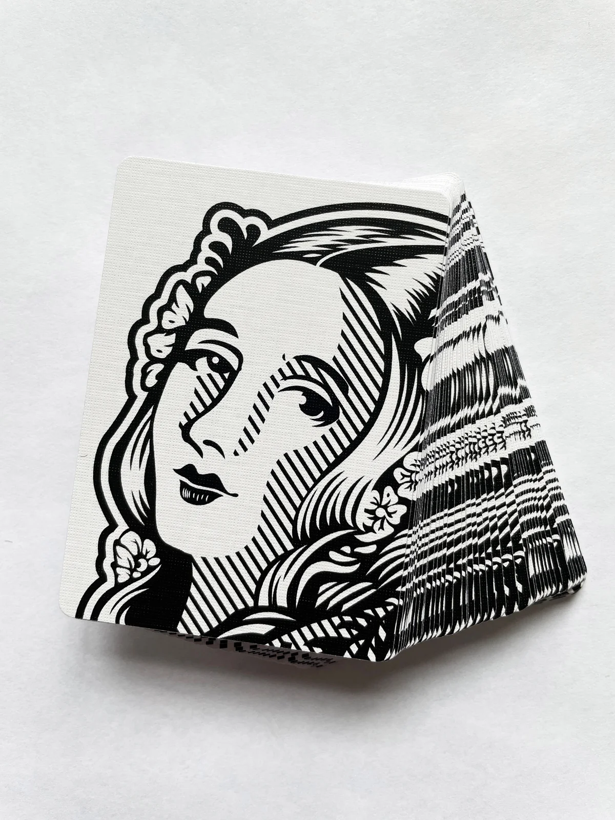 Stack of cards showing the black-and-white illustrated back design.