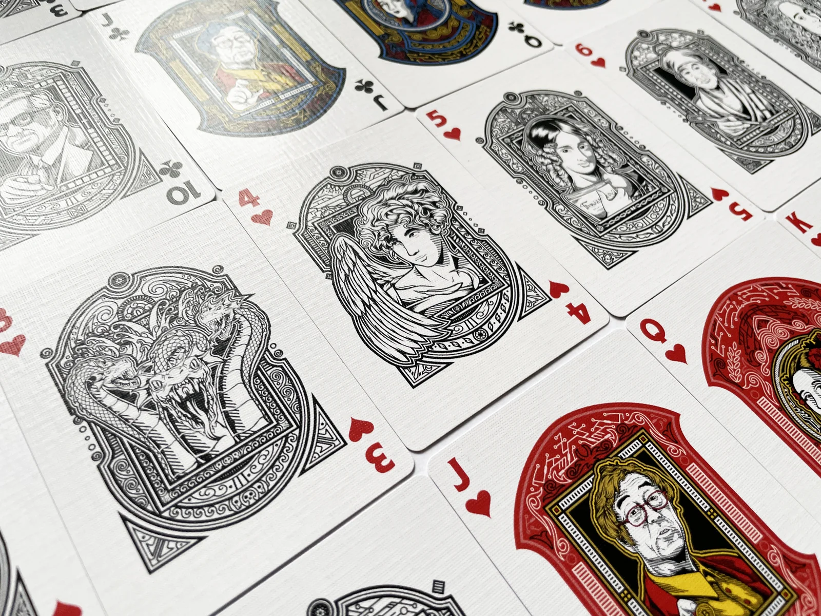 Variety of illustrated playing cards arranged on a pale surface.